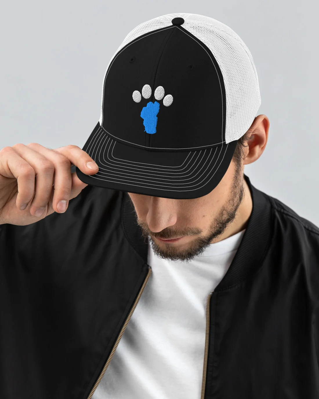 The Tahoe Bark Co Logo design on a trucker cap, worn by a model.