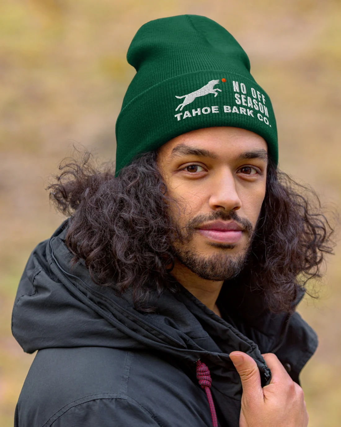 The No Off Season design on a beanie, worn by a model.
