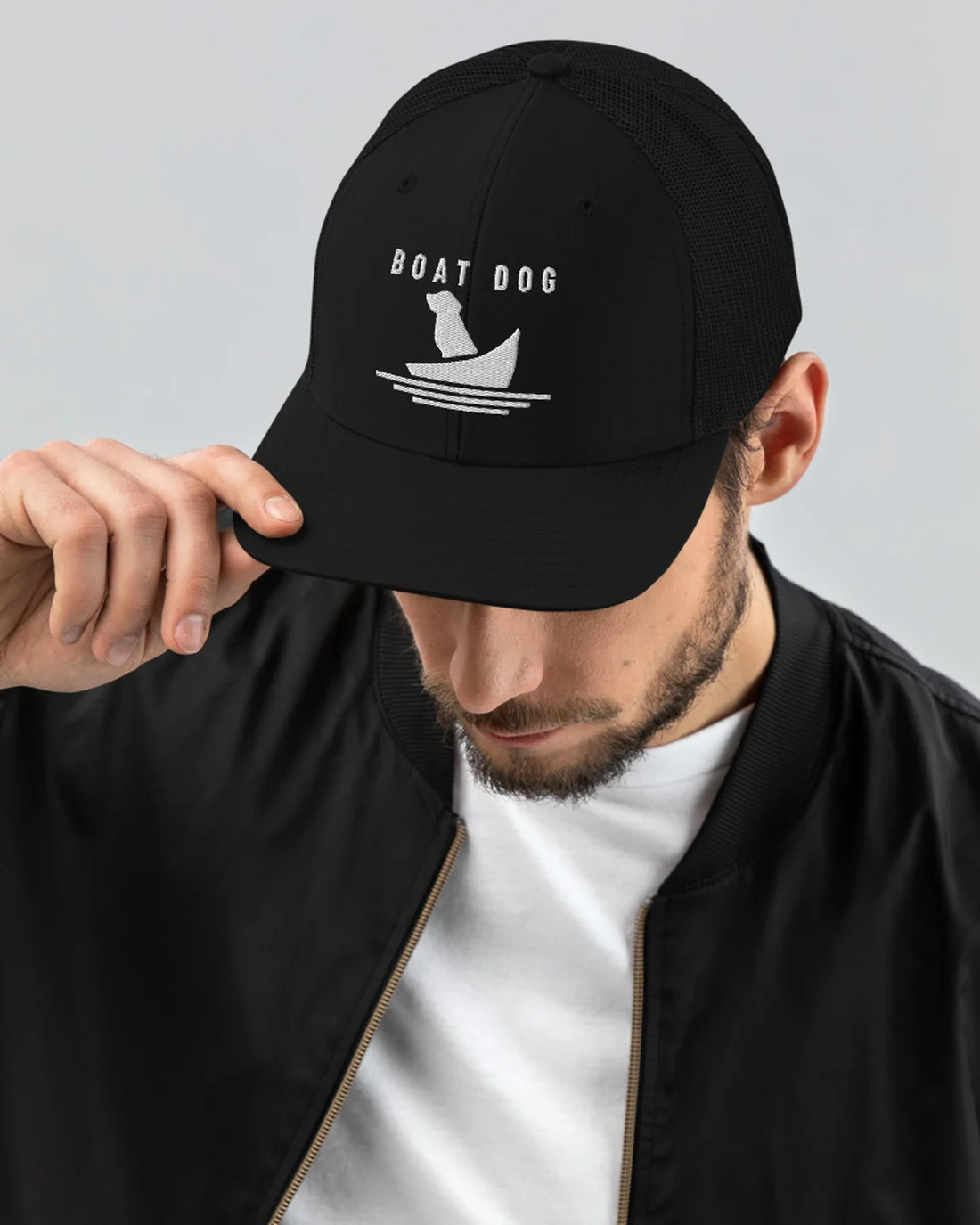 The Boat Dog design on a trucker cap, worn by a model.
