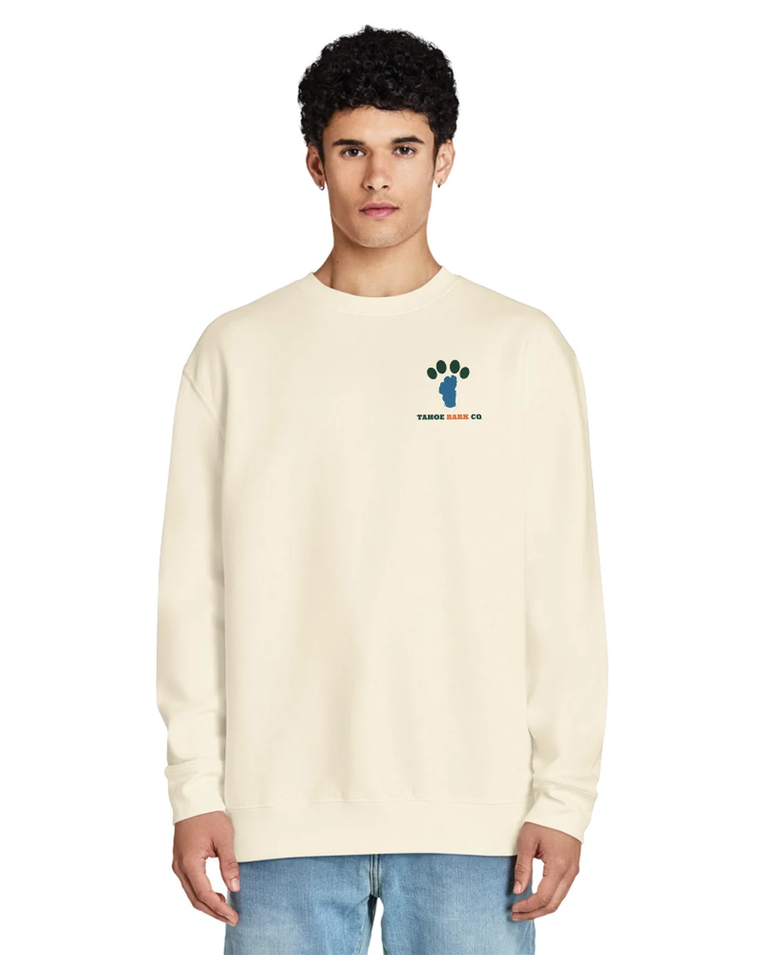 The front of the Emerald Bay Dog Club crewneck, worn by a second model, with the Tahoe Bark Co. logo at the heart.