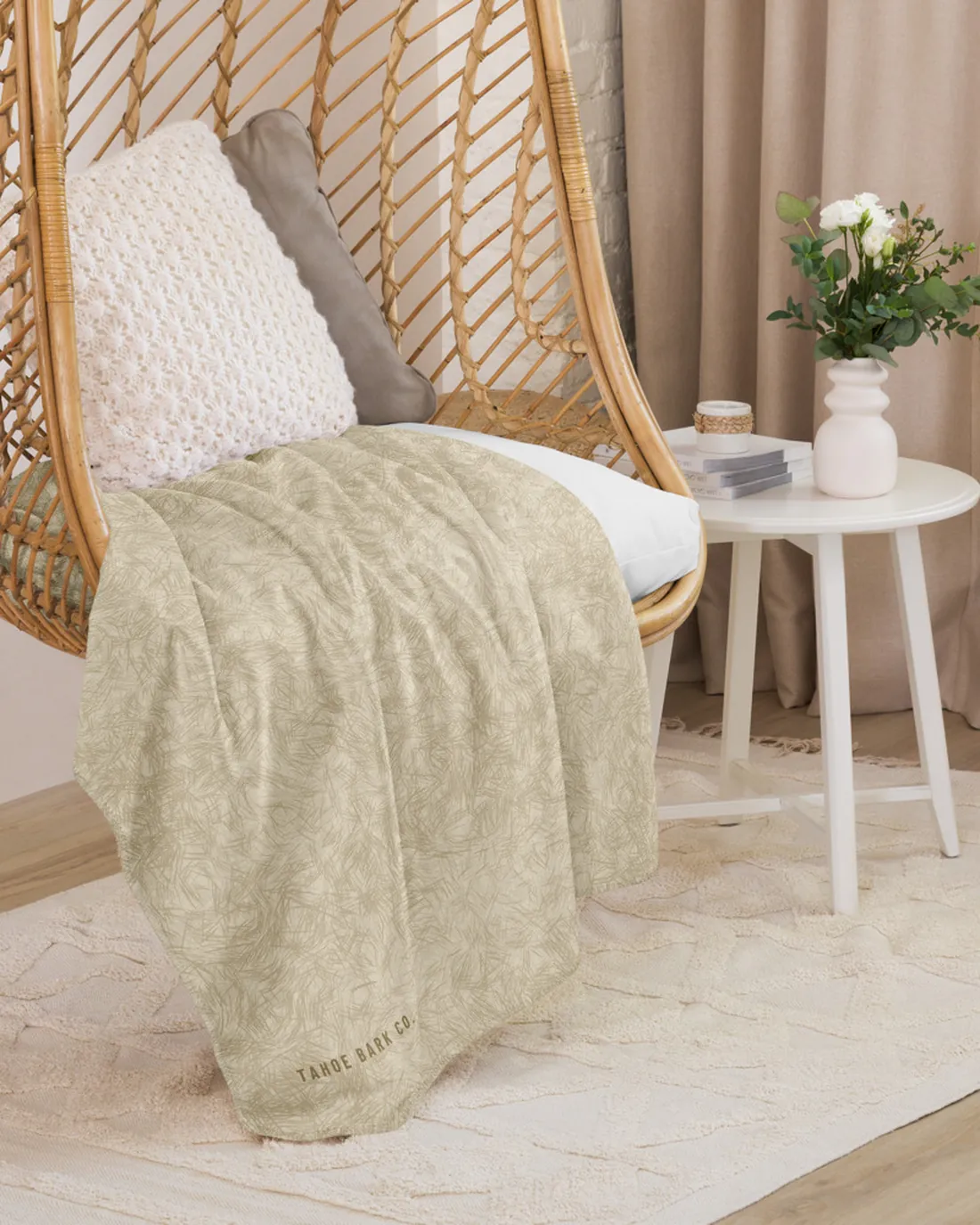 The Coat Match design in Golden on a blanket, draped over a hanging chair.